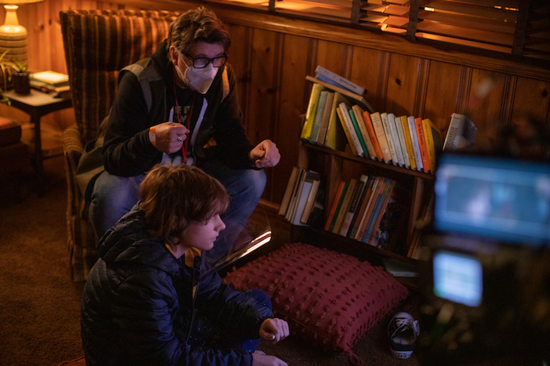 (from left) Director Scott Derrickson and Mason Thames on the set of The Black Phone.